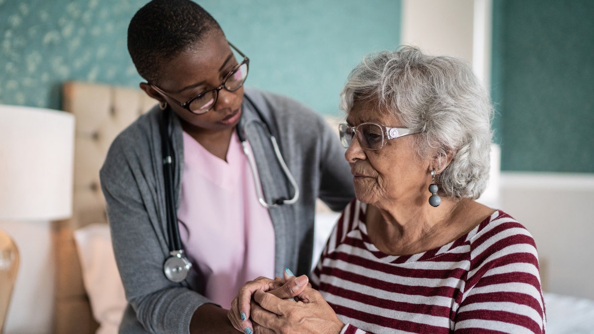 An elderly woman with a carer