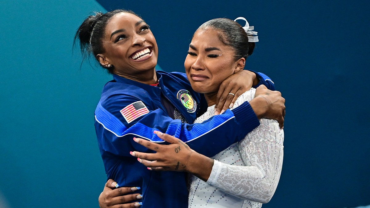 Simone Biles and Jordan Chiles hug each other