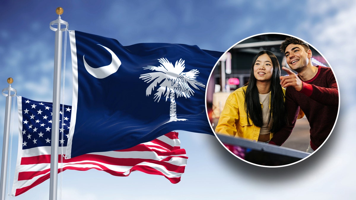 Couple playing pinball, South Carolina and American flag in the background