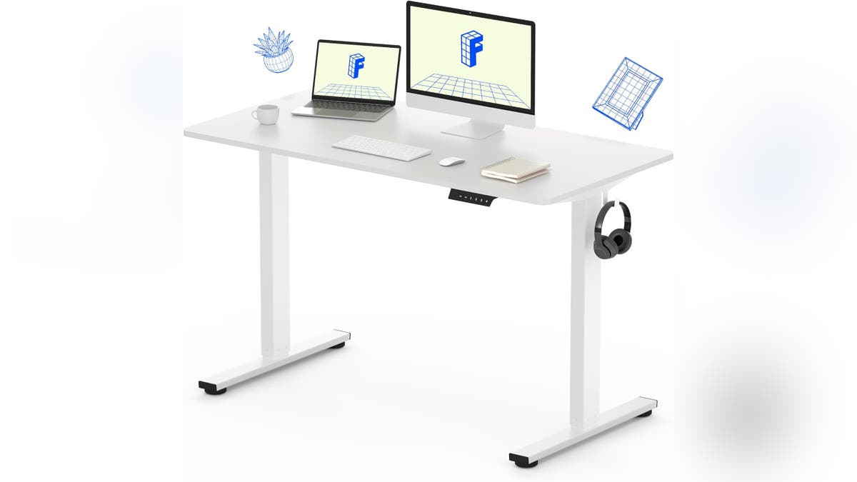 An electrically adjustable desk for standing or sitting.