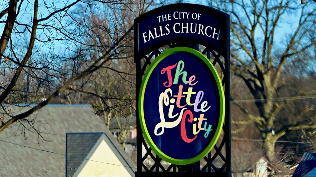 A colorful "the little city" sign