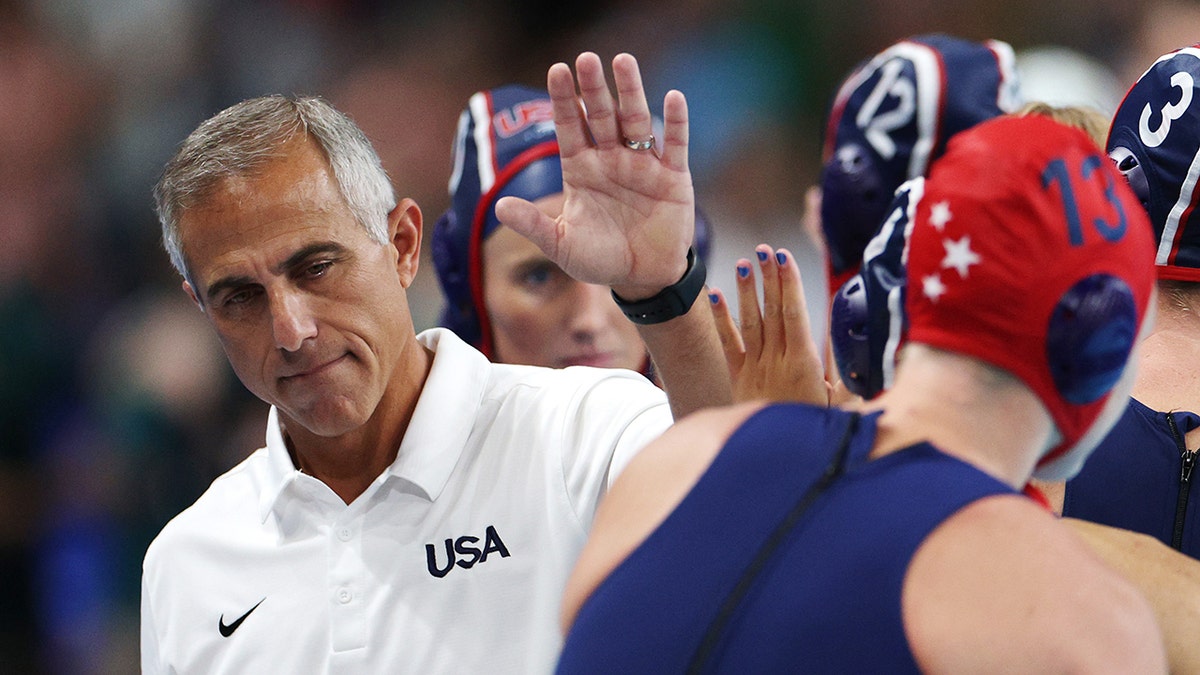 Team USA head coach Adam Krikorian consoles his team after defeat following the penalty shootout.