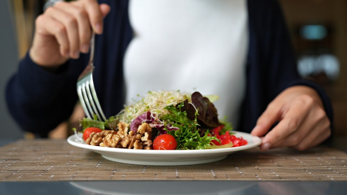 A woman eating a salad