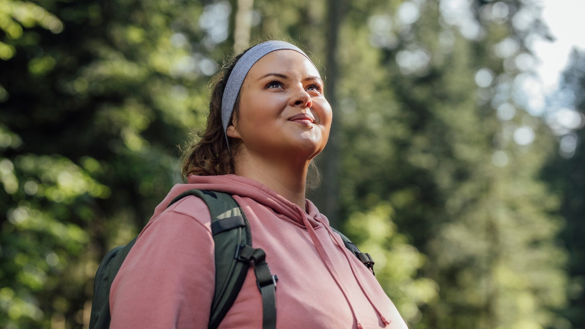 A woman smiling on a hike