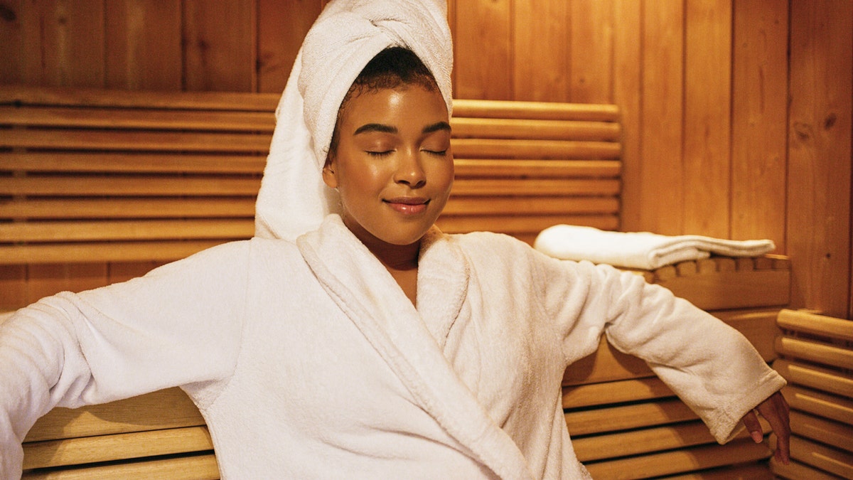 A woman sitting in the sauna.