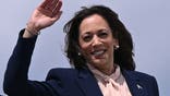 TOPSHOT - US Vice President and 2024 Democratic presidential candidate Kamala Harris waves as she boards Air Force Two at Joint Base Andrew in Maryland on August 6, 2024. Harris is attending a campaign event in Philadelphia after unveiling Minnesota Governor Tim Walz as her vice presidential running mate. (Photo by Brendan SMIALOWSKI / POOL / AFP) (Photo by BRENDAN SMIALOWSKI/POOL/AFP via Getty Images)