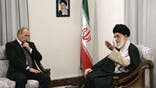 A picture made available 17 October 2007 shows Russian President Vladimir Putin (L) meeting with Iranian supreme leader Ayatollah Ali Khamenei (R) in Tehran, 16 October 2007. On the wall is a portrait of the late Iranian revolutionary founder Ayatollah Ruhollah Khomeini. "Vladimir Putin will remain national leader, regardless of the post that he holds," wrote Boris Gryzlov, head of the ruling United Russia party, in the 17 October 2007 government newspaper Rossiiskaya Gazeta. MIKHAIL KLIMENTYEV/AFP via Getty Images