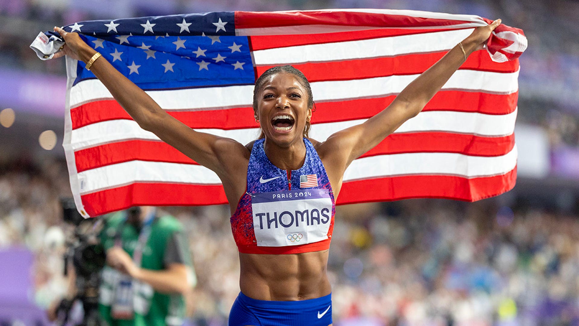 Gabby Thomas celebrates with the American flag
