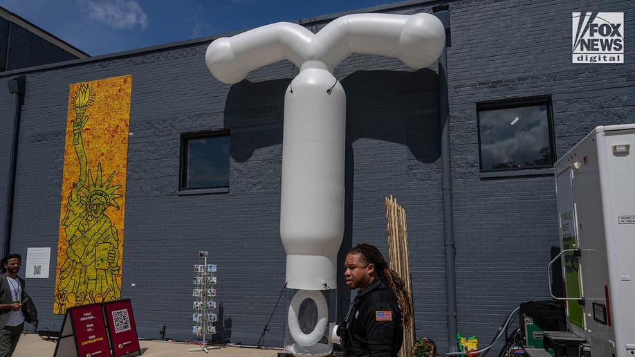 I giant inflatable IUD is attached to a wall