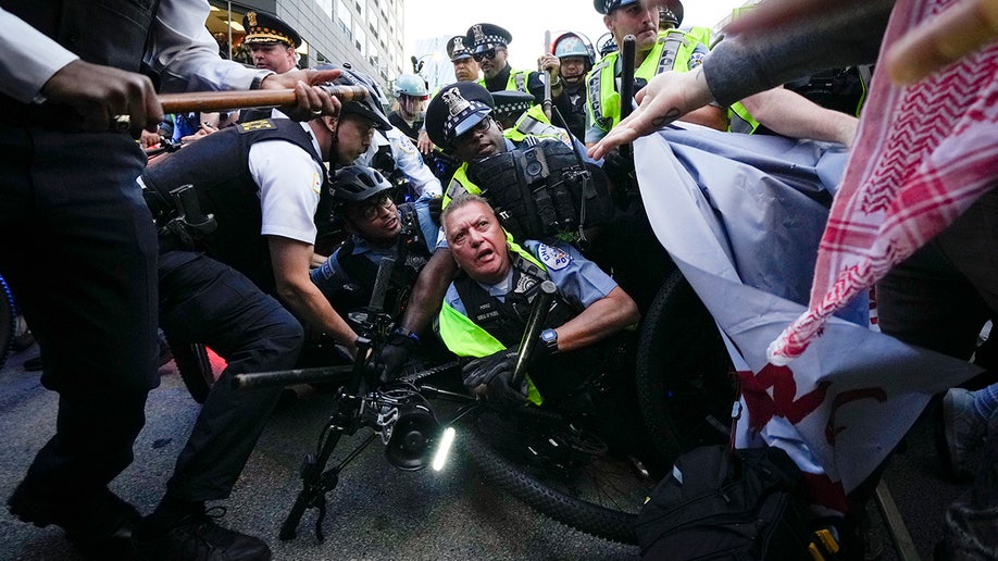 Demonstrators clash with police near the Israeli Consulate during the Democratic National Convention