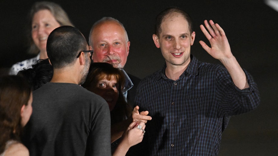 Former prisoner held by Russia US journalist Evan Gershkovich waves as he arrives at Joint Base Andrews