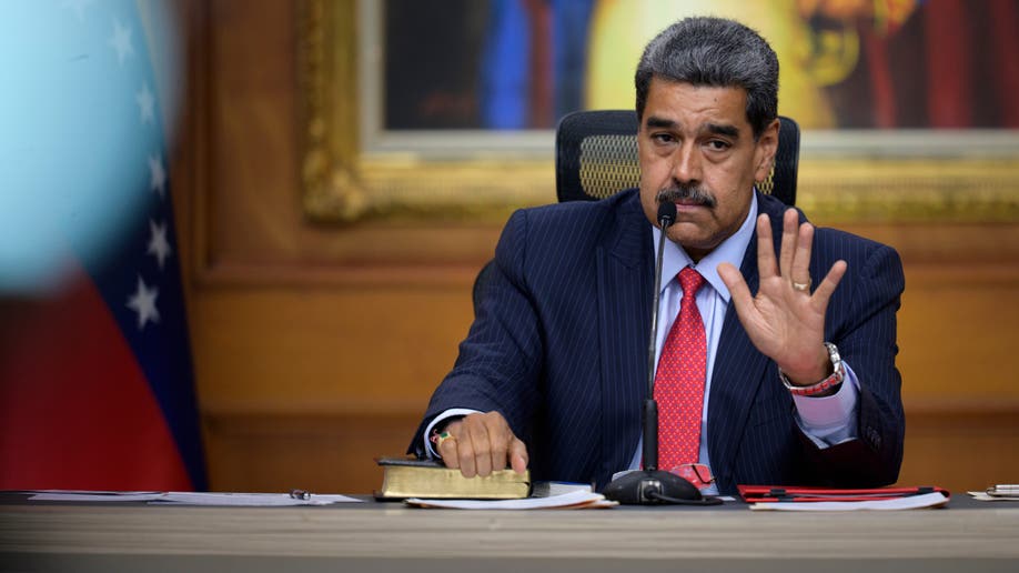 Nicolás Maduro with his hand up while speaking