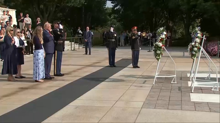 Trump places his hand over his heart as music plays