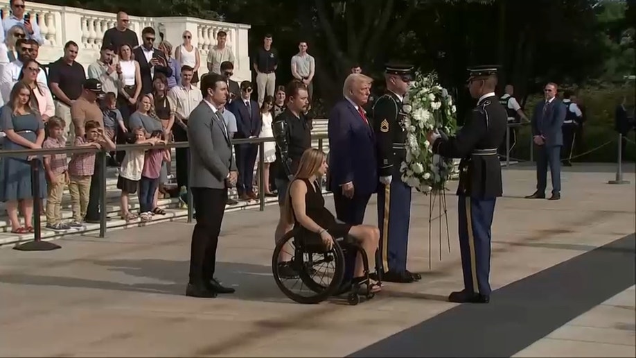 Trump with a woman in a wheelchair, a paraplegic and another man laying a wreath