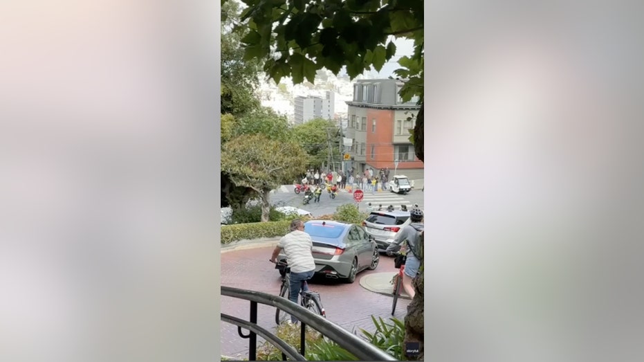 WATCH: San Francisco traffic officer circled by masked motorcyclists in tourist area