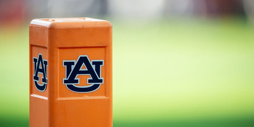 Auburn cheeleader knocks down Oklahoma player running onto field while performing stunts