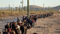 Immigrants line up at a remote U.S. Border Patrol processing center after crossing the U.S.-Mexico border on December 07, 2023 in Lukeville, Arizona. A Department of Homeland Security Threat Assessment warned of migrants with ties to terrorism exploiting the border crisis. - Fox News