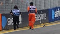Track marshals chase a lizard from the track during final practice ahead of the F1 Grand Prix of Singapore at Marina Bay Street Circuit on September 21, 2024 in Singapore, Singapore. - Fox News