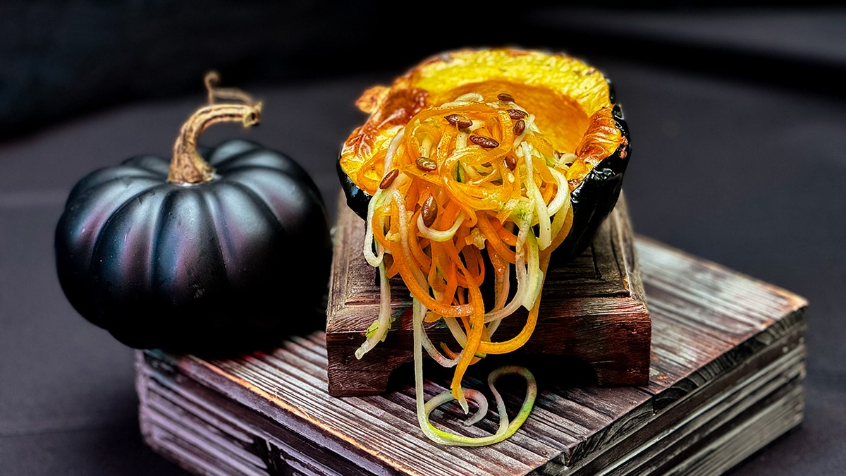 A piece of pumpkin with "noodles" made from zucchini and butternut squash