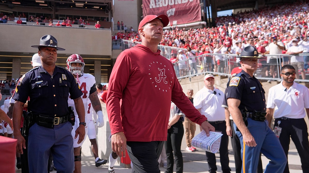 Kalen DeBoer walks through the field