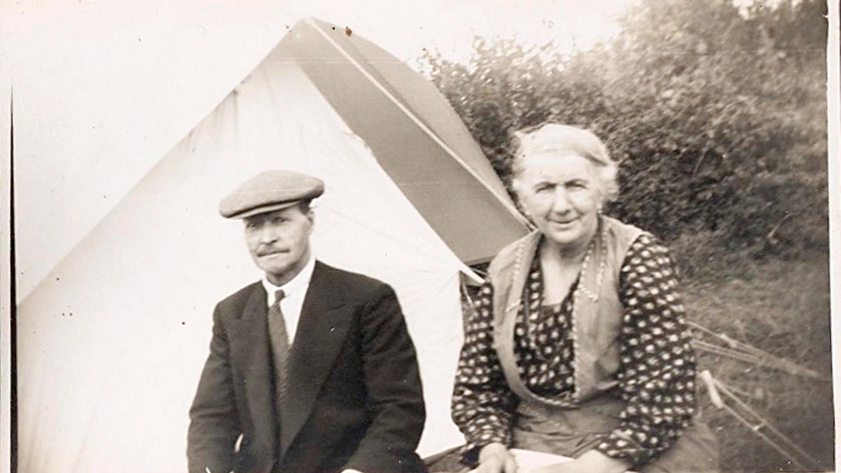 A black and white photo of a man and a woman. 