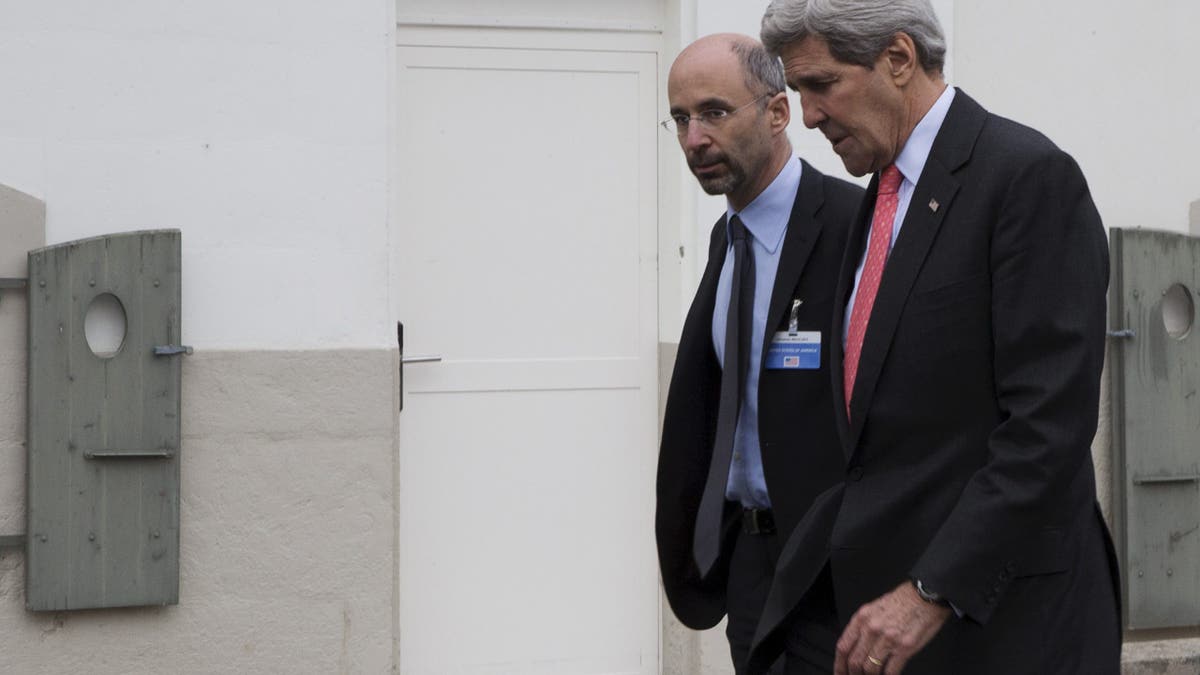 Malley, a controversial Washington figure, walks with former Secretary of State John Kerry.