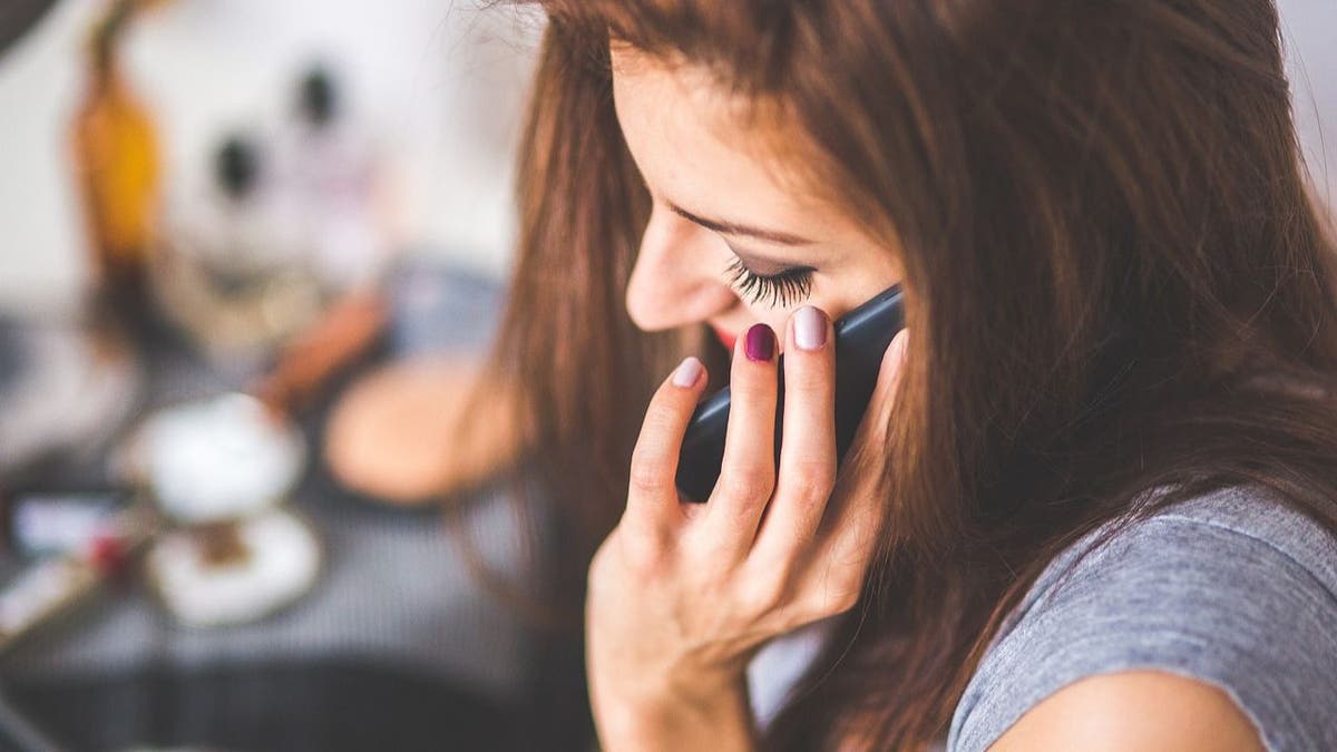 The woman talks on the phone 