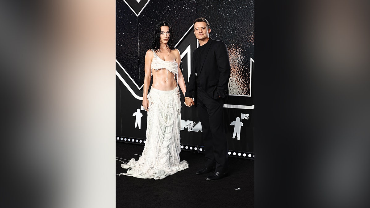 Katy Perry and Orlando Bloom walked the 2024 MTV VMA red carpet together. Perry wore a two-piece white set and Bloom wore a black suit.