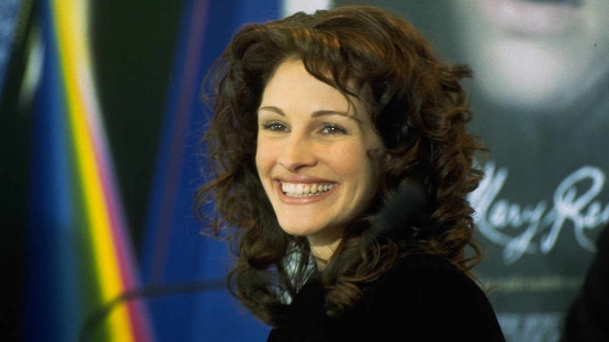 Curly-haired Julia Roberts smiles for a photo in Berlin