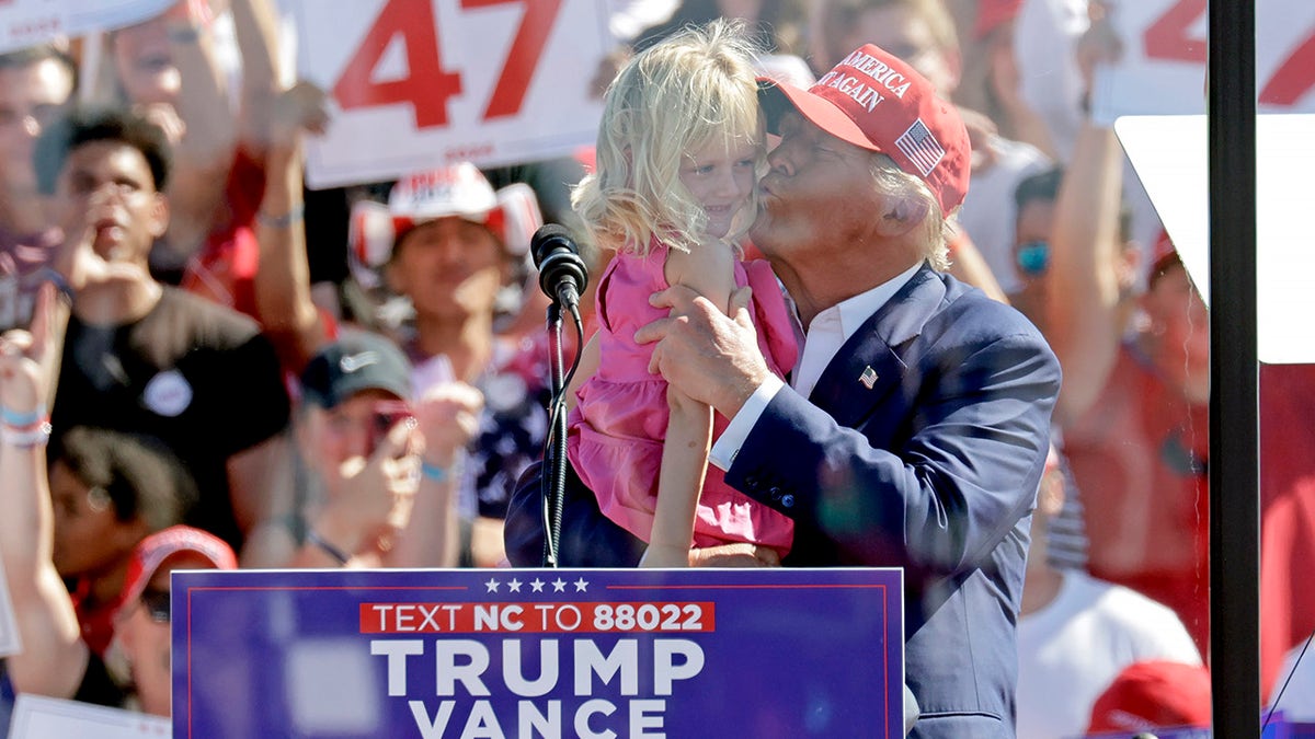 Trump kisses granddaughter Carolina at Wilmington rally