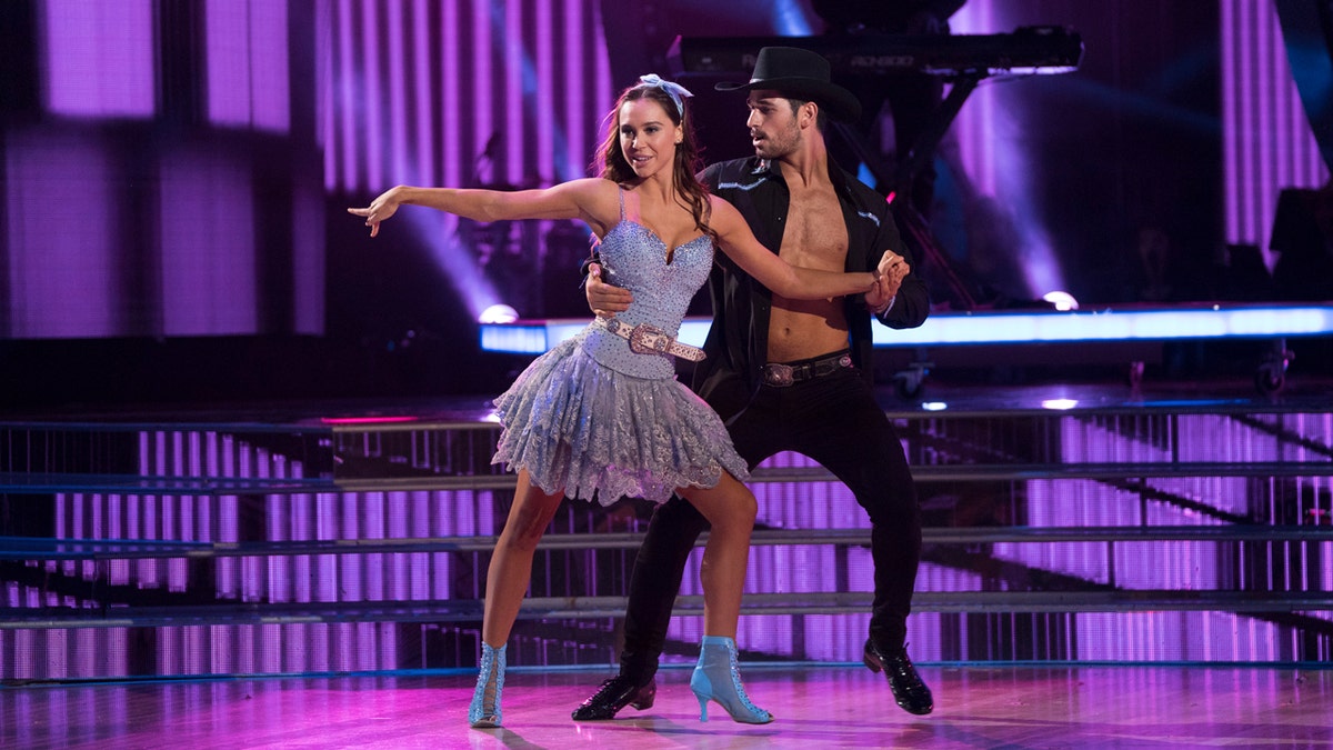 Alexis Ren and Alan Bersten dance on stage