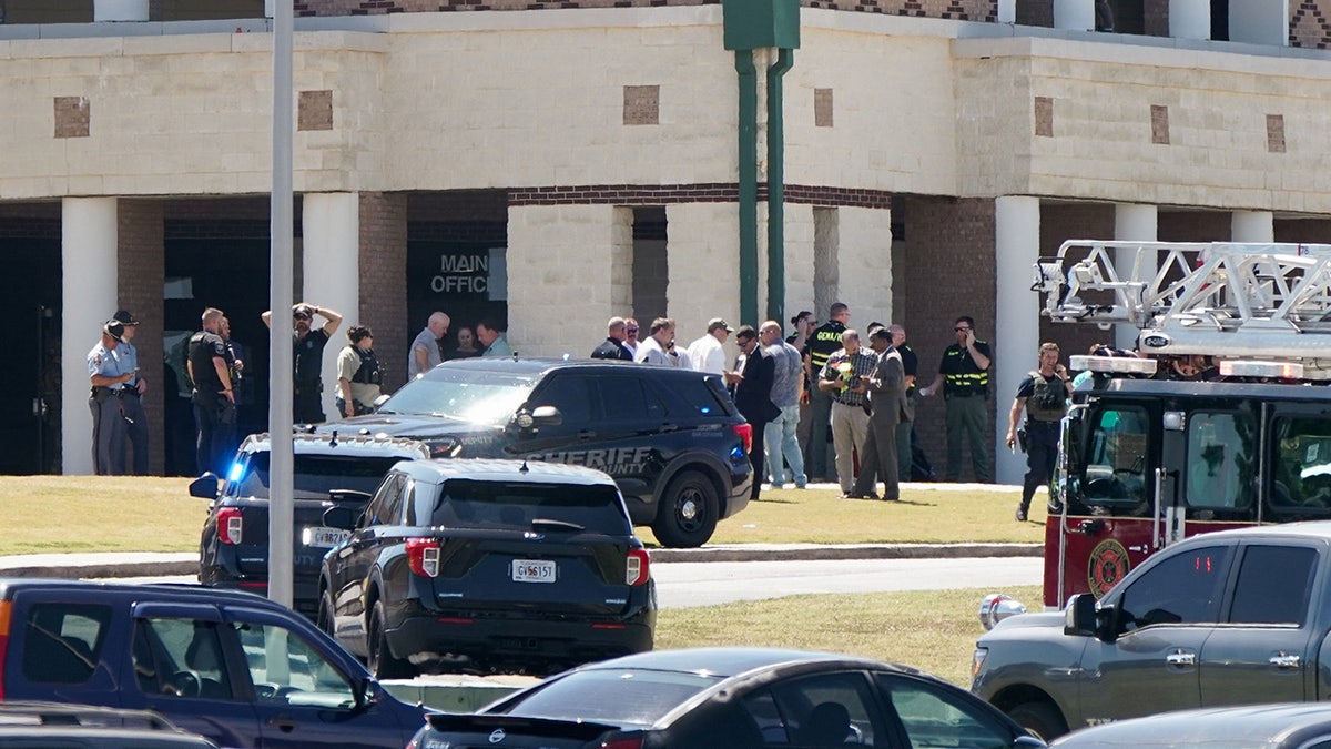 Law enforcement officers work at the scene of a shooting at Apalachee High School