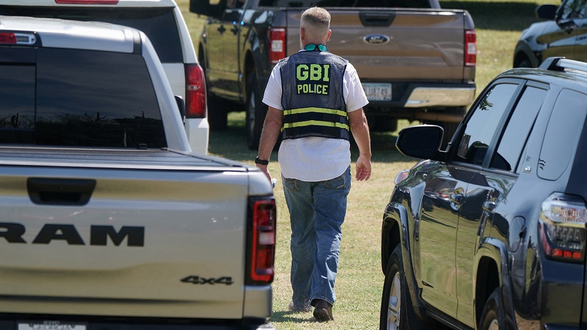 A law enforcement officer works near the scene of a shooting at Apalachee High School