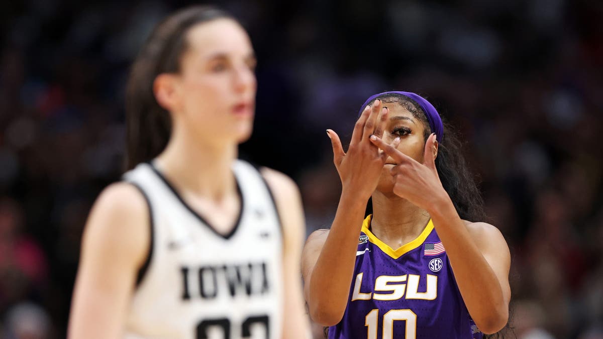 Angel Reese of the LSU Lady Tigers reacts towards Caitlin Clark