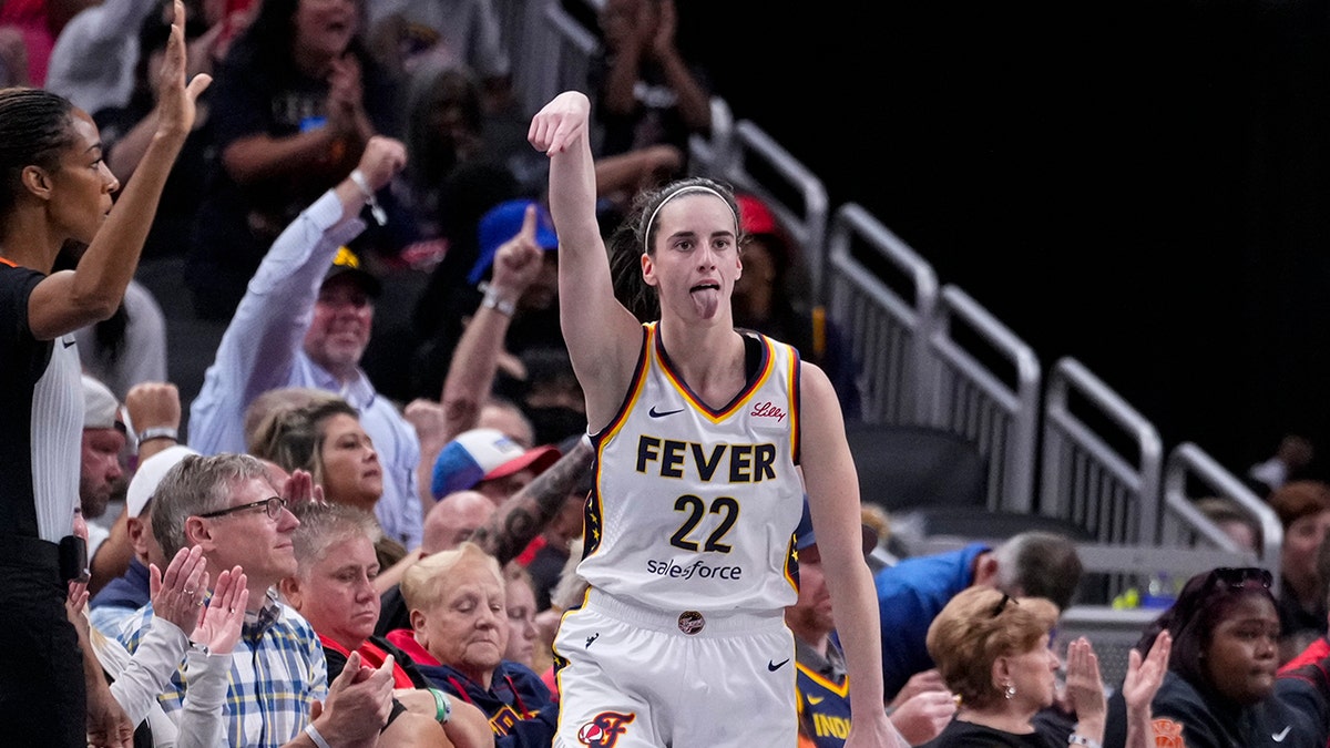 Caitlin Clark reacts after making a basket