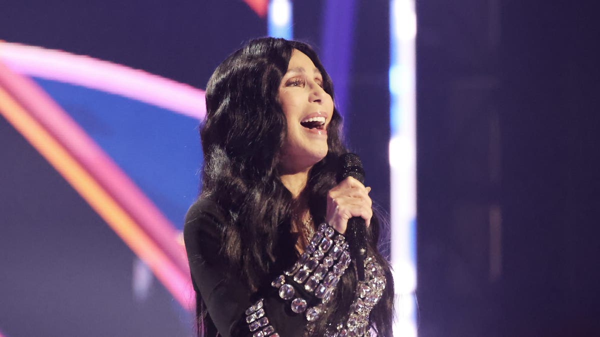 Cher sings into the microphone