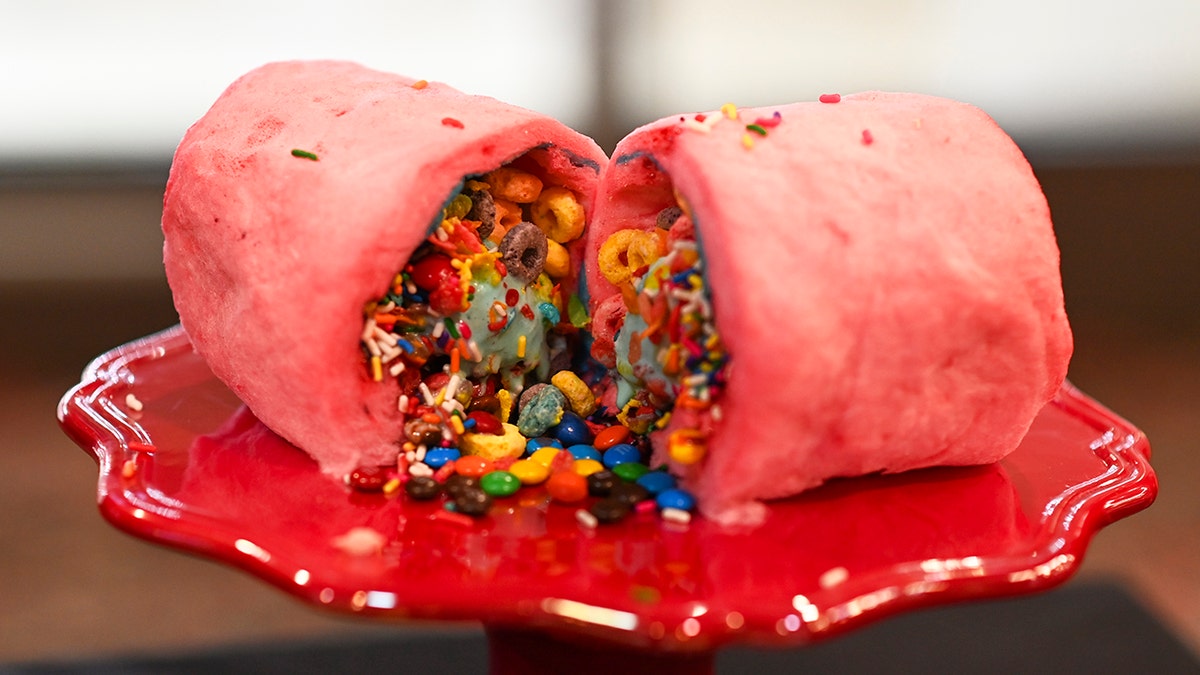 A "burrito" made of rolled up cotton candy stuffed with candy, ice cream, and sprinkles.