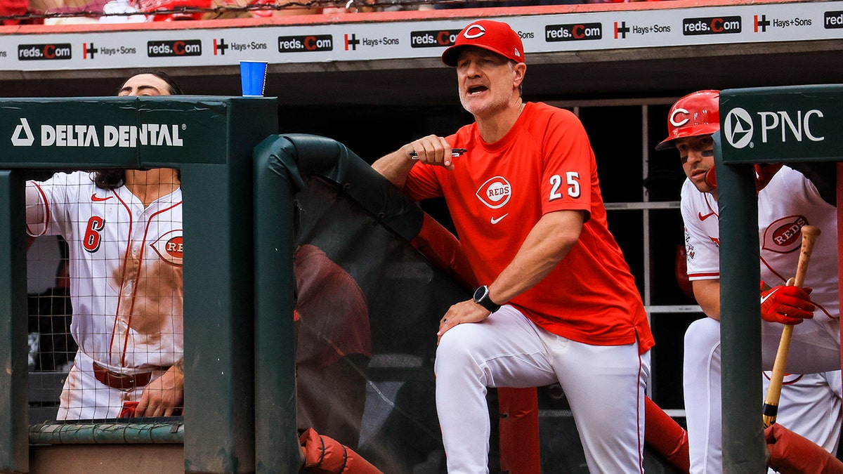 David Bell officiates the game between the Reds and the Pirates