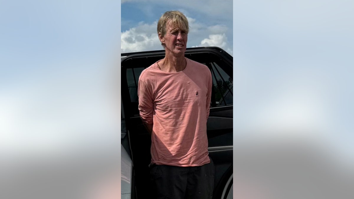 Ryan W. Routh stands in handcuffs after his arrest