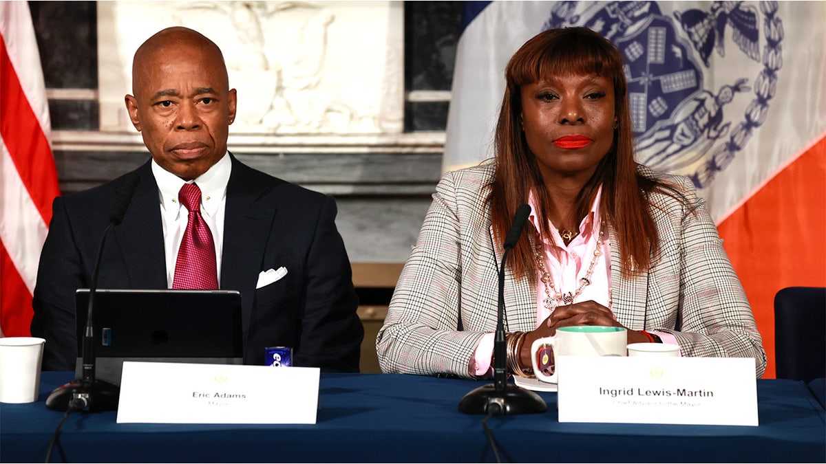 Mayor Eric Adams sits next to chief advisor Ingrid Lewis-Martin