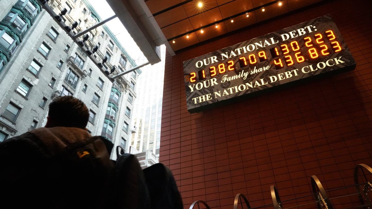 A man walks past the National Debt Clock on 43rd Street in downtown New York City, February 15, 2019. The debt has now surpassed $35 trillion. (Getty Images)