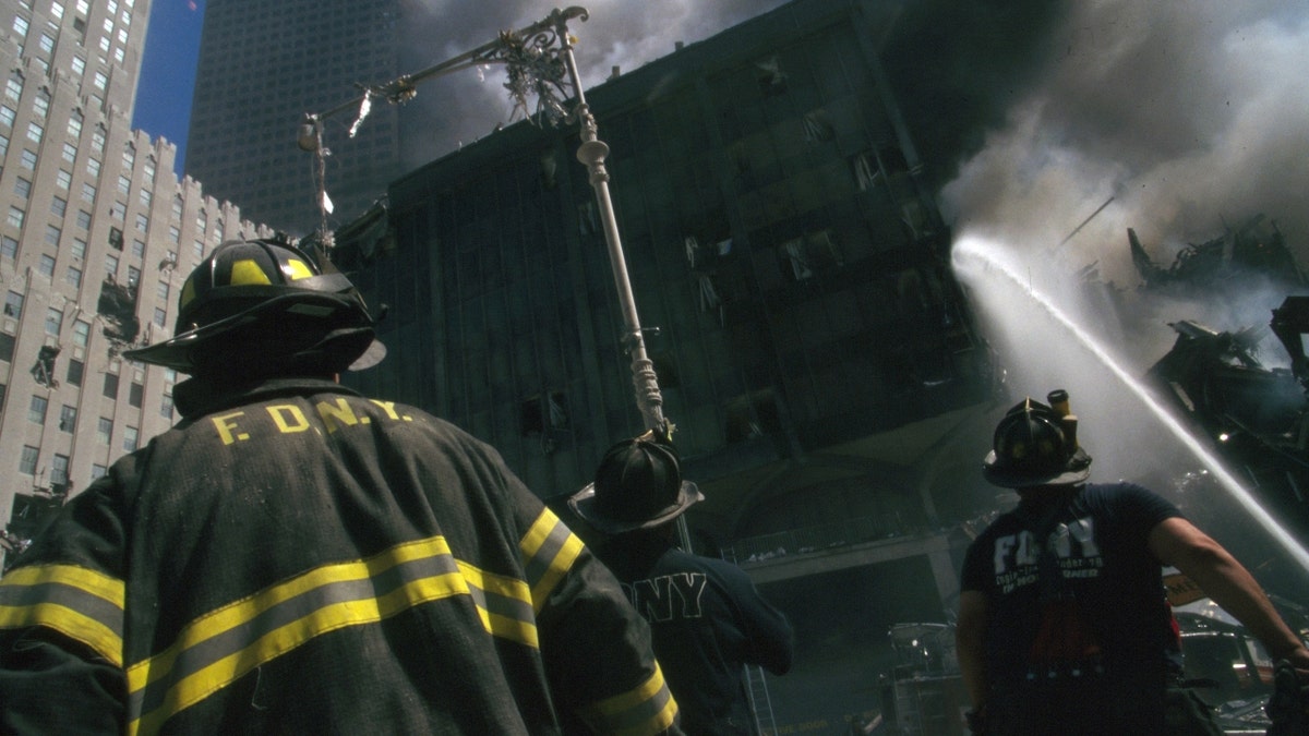 Color photograph of a New York firefighter amidst the rubble of the World Trade Center after the September 11 attacks. 