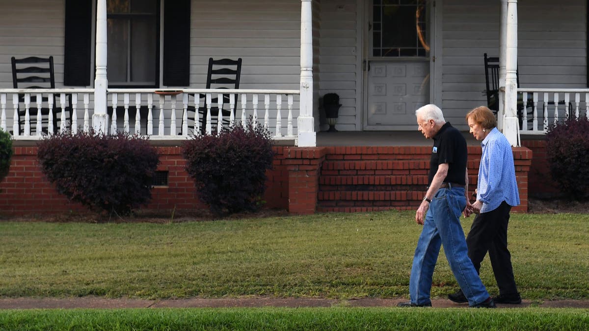 Former President Carter and his wife Rosalynn appear on a stroll through their hometown of Plains, Georgia.