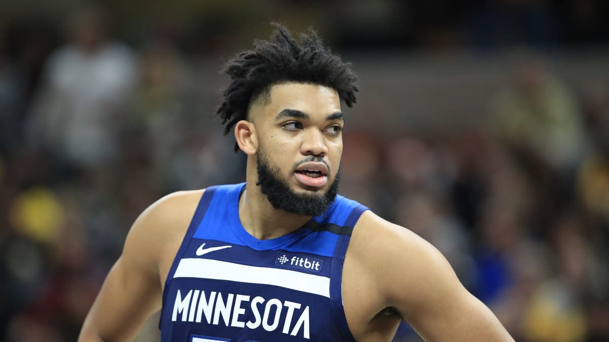 Karl Anthony-Towns wears a blue jersey