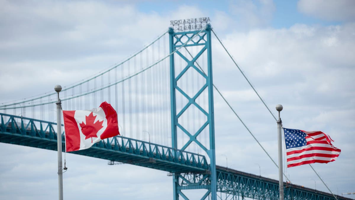 Ambassador Bridge in Detroit, Michigan with Canada, US flags shown