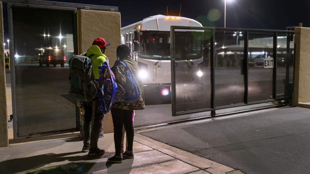 A Haitian household  stands extracurricular  the U.S. Border Patrol detention installation  aft  walking from the Mexican borderline  done  Yuma, Ariz., connected  Dec. 8, 2021.