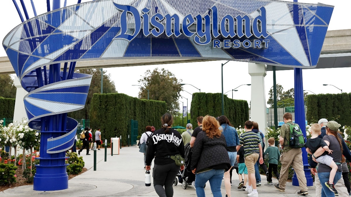 People walk into Disneyland in California