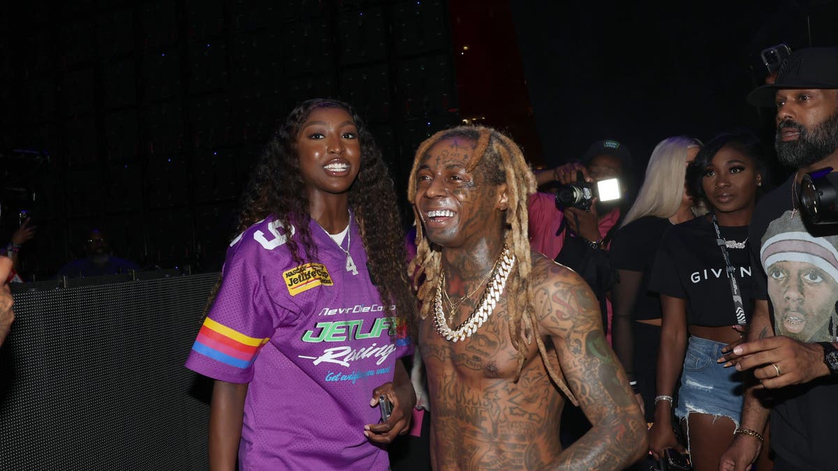 Flau'jae Johnson and Lil Wayne attend an event