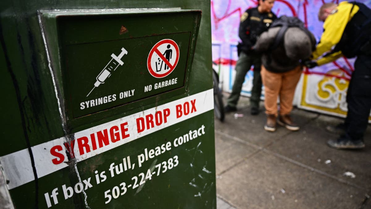 A syringe drop box stands on the street as a Portland Police officer conducts an investigation into drug dealing and issues a citation for drug possession during a patrol in downtown Portland, Oregon on January 25, 2024. (Photo by Patrick T. Fallon / AFP) (Photo by PATRICK T. FALLON/AFP via Getty Images)