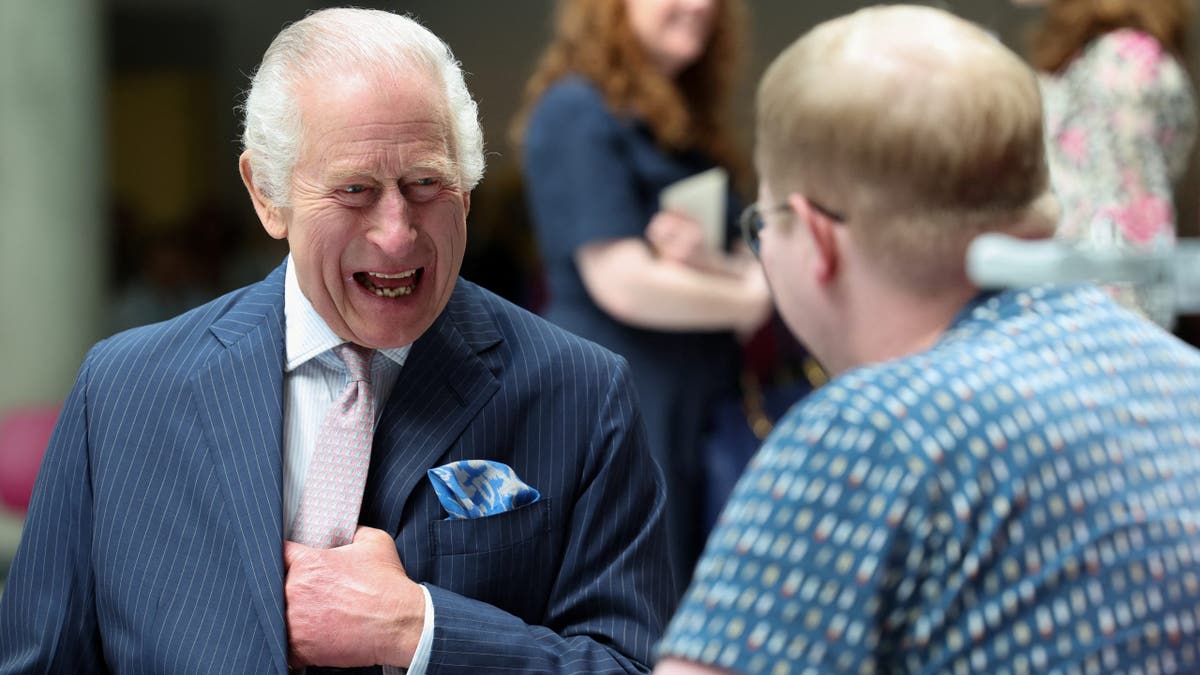 King Charles III meets with patient Jasper Keech during a visit at the University College Hospital Macmillan Cancer Centre on April 30,